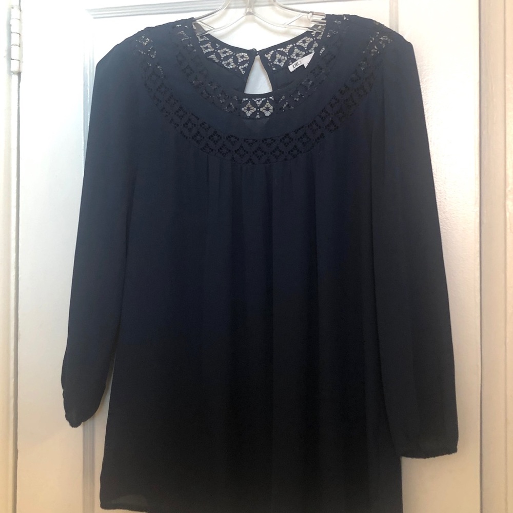 Blouse with lace trim.